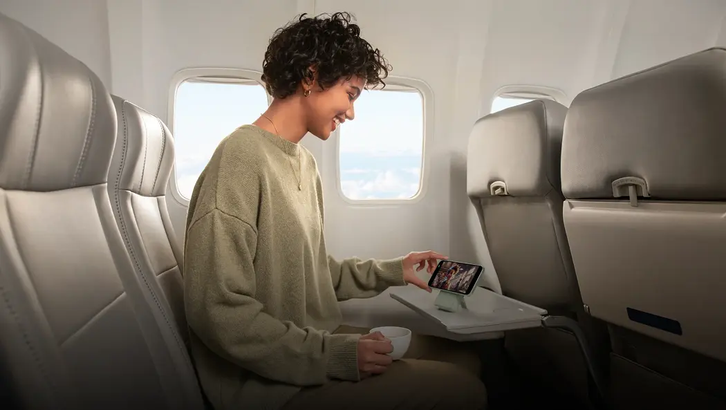 A woman using anker product while travelling